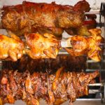 Rotisserie chicken, tri tip and pork cooking in the rotisserie