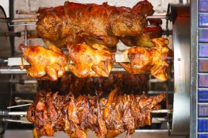 Rotisserie chicken, tri tip and pork cooking in the rotisserie